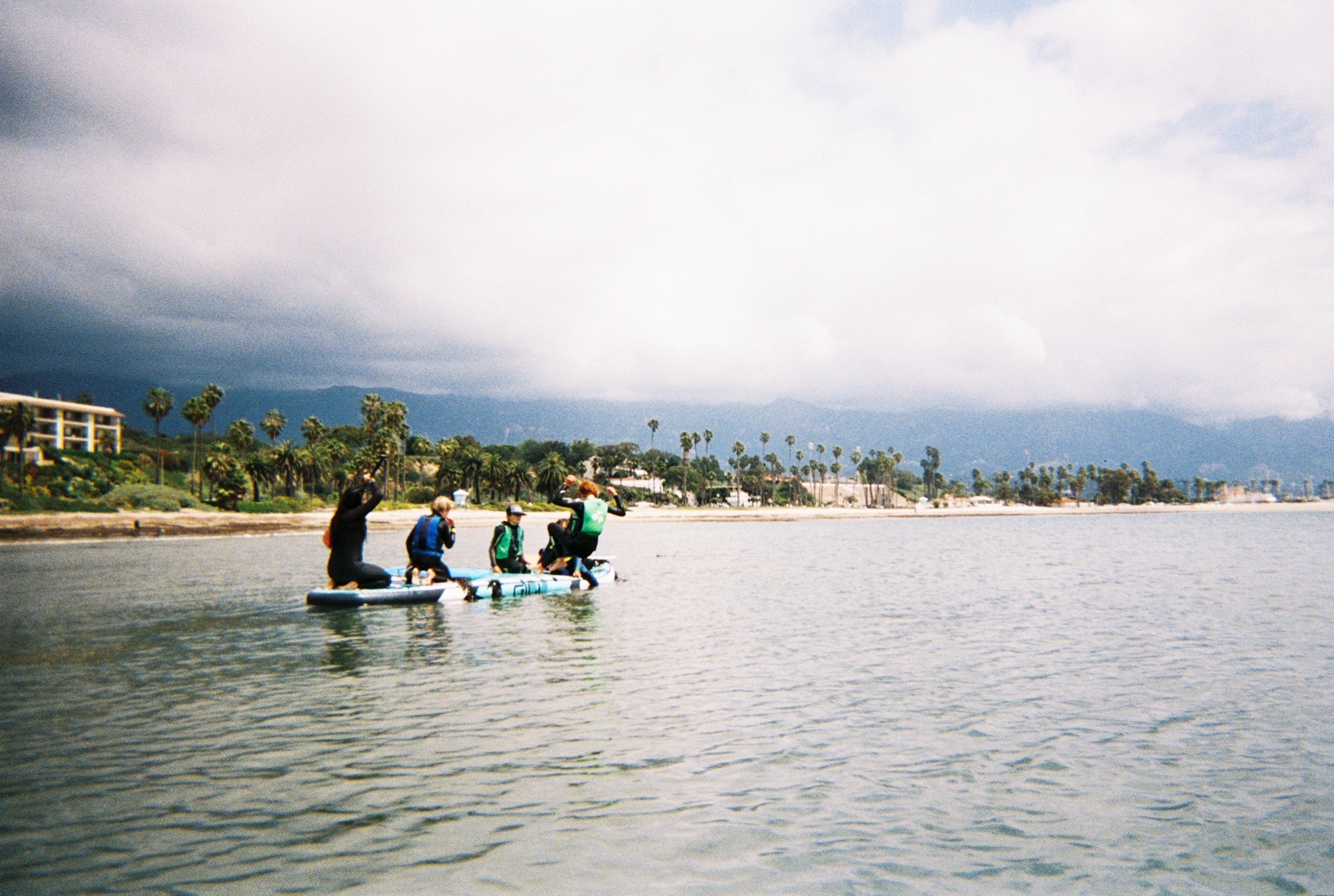 Kids in wetsuits getting ready to paddle out