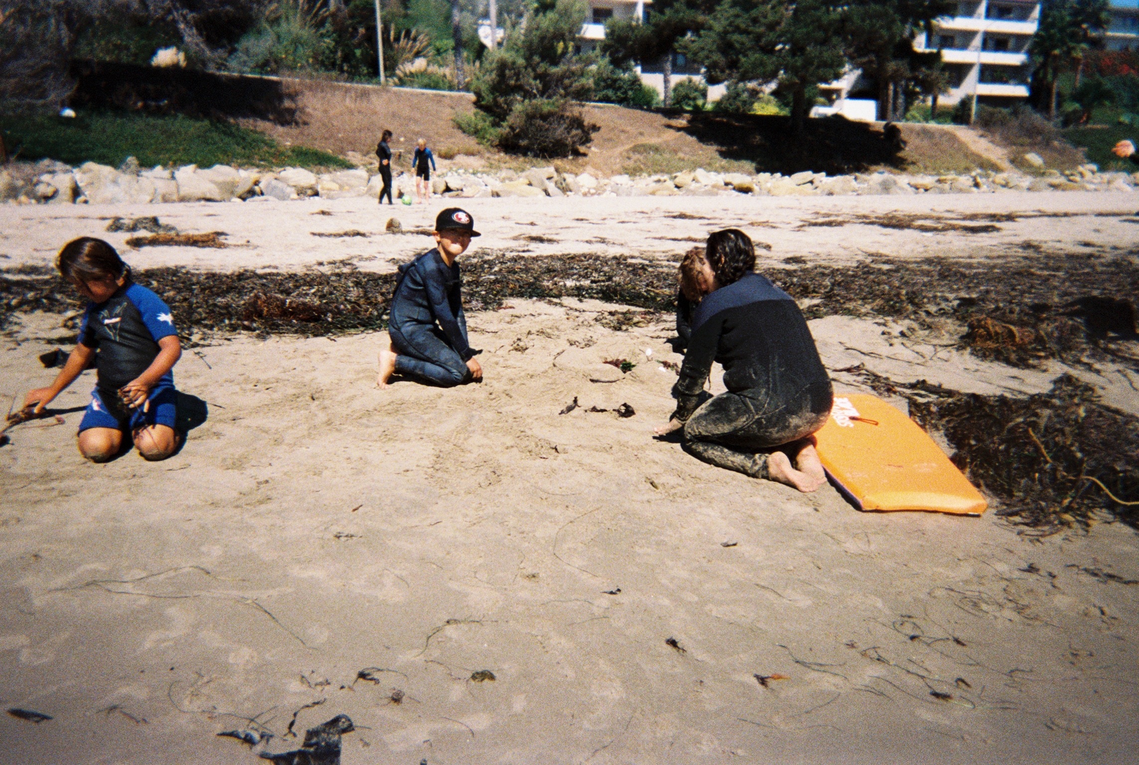 A kid learning to surf on a soft-top board