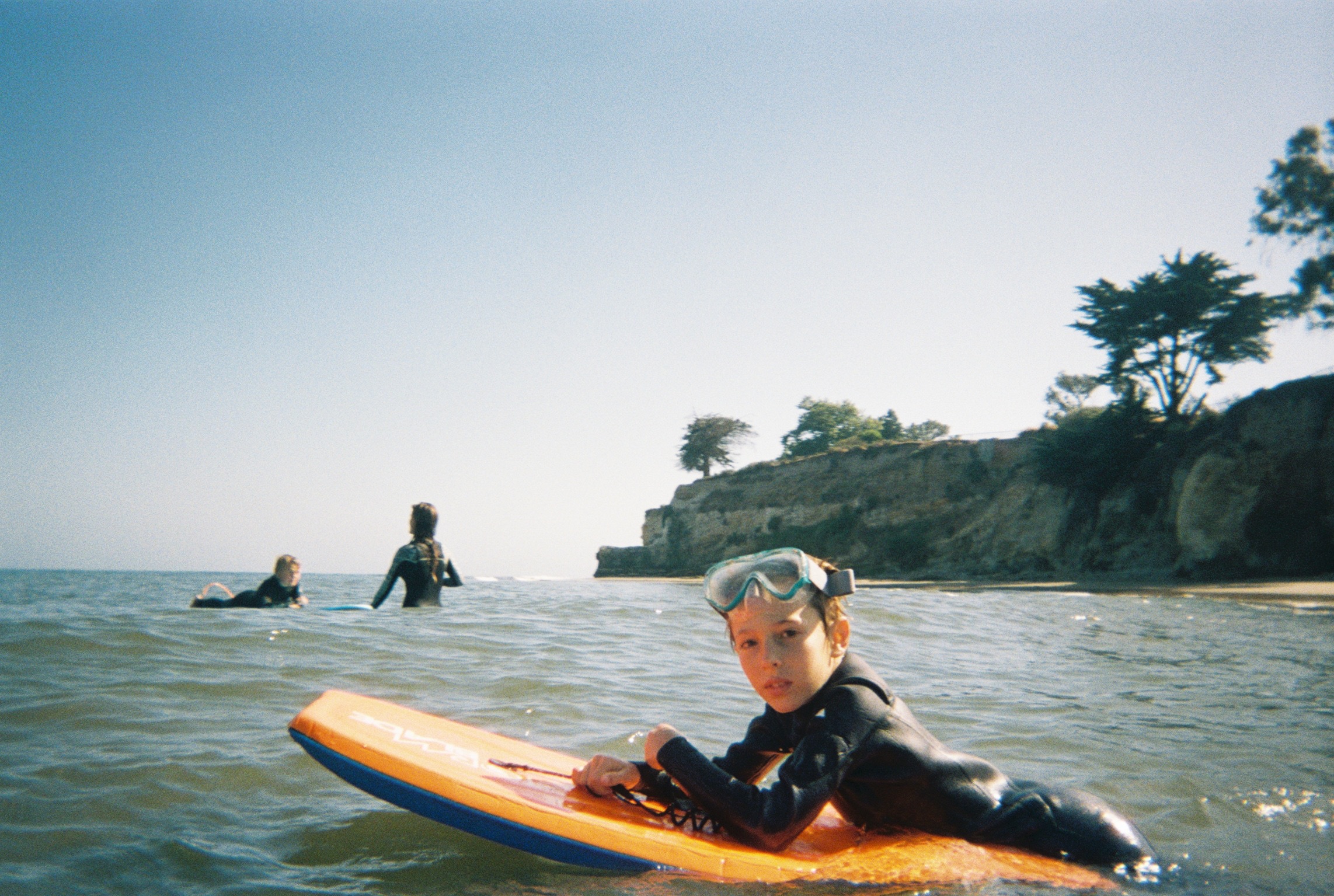 A kid catching their first wave with a Sea League coach